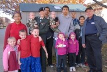 PFC Siobahn Healy with her husband Christopher Healy and 12 of her 13 children pose for a family picture after her graduation from Advanced Individual Training, Edgewood, Maryland. Photo by SPC Loni Kingston